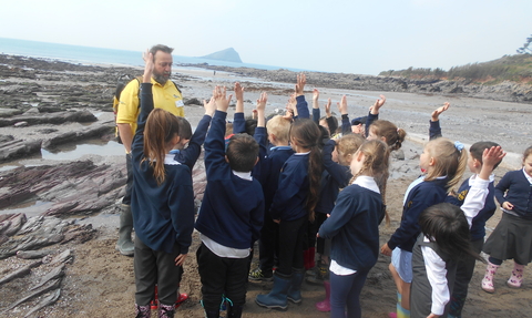 Wembury assistant delivering talk on beach to pupils from woodfield primary school in Plymouth